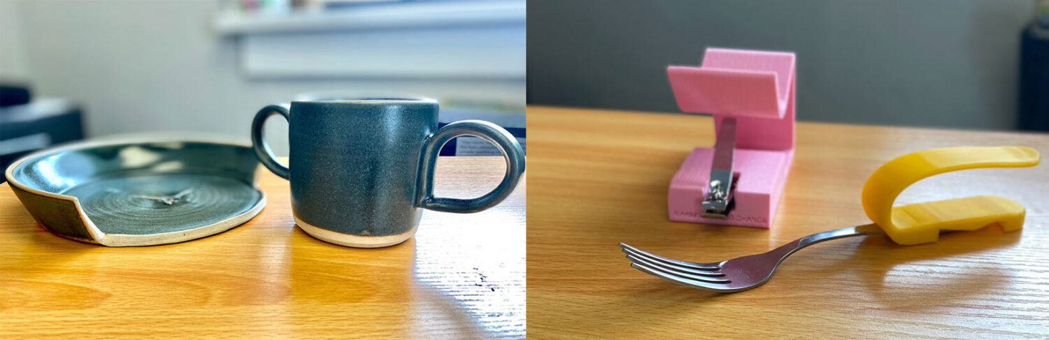 A wooden table displays a chipped ceramic plate, a blue mug, a pink nail clipper, a fork with a yellow adaptive handle, and a blurred background.