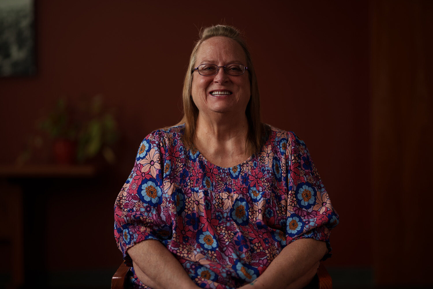 A woman sitting in a chair smiling. profile picture