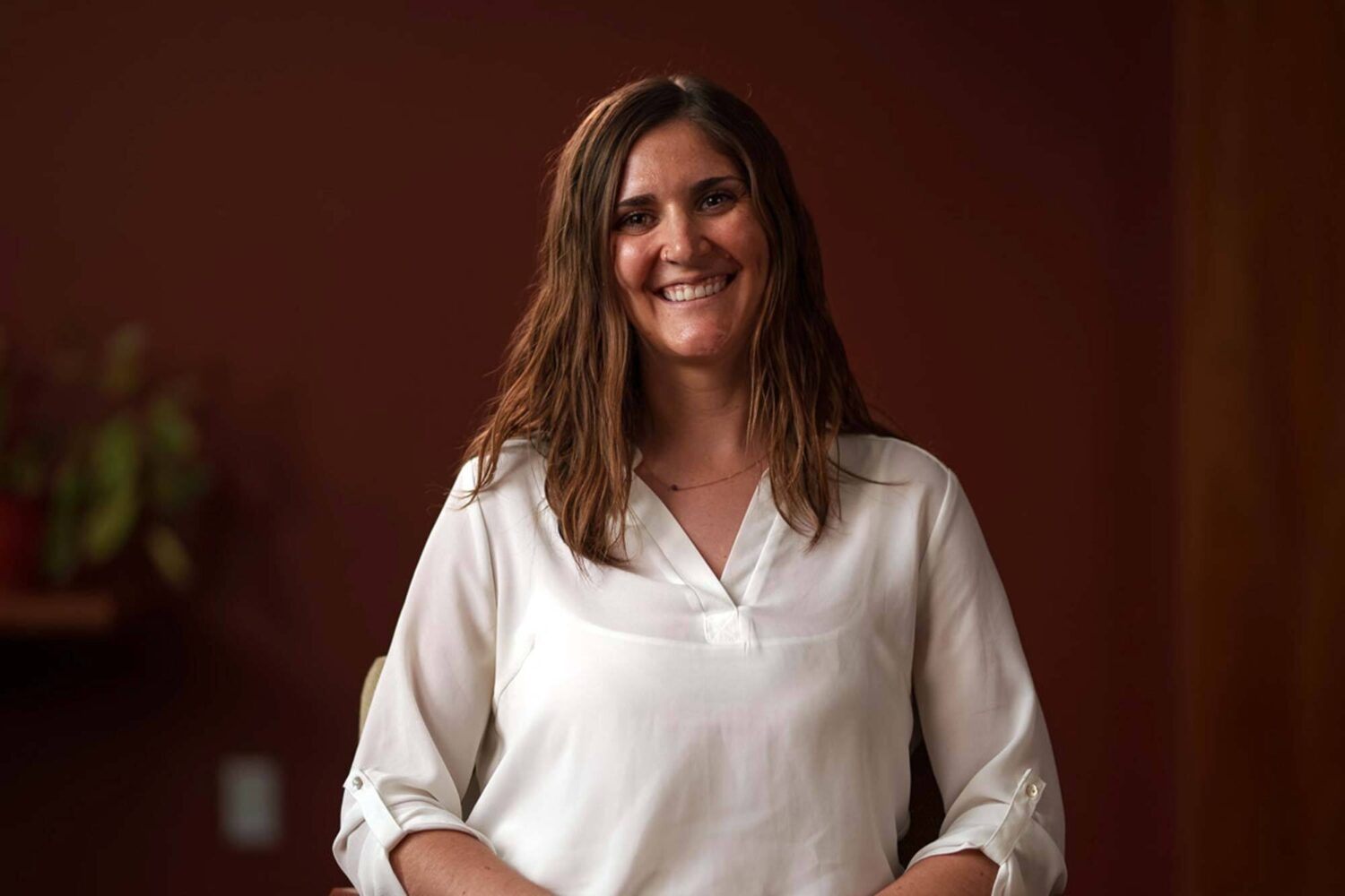 A woman sitting in a chair smiling. profile picture