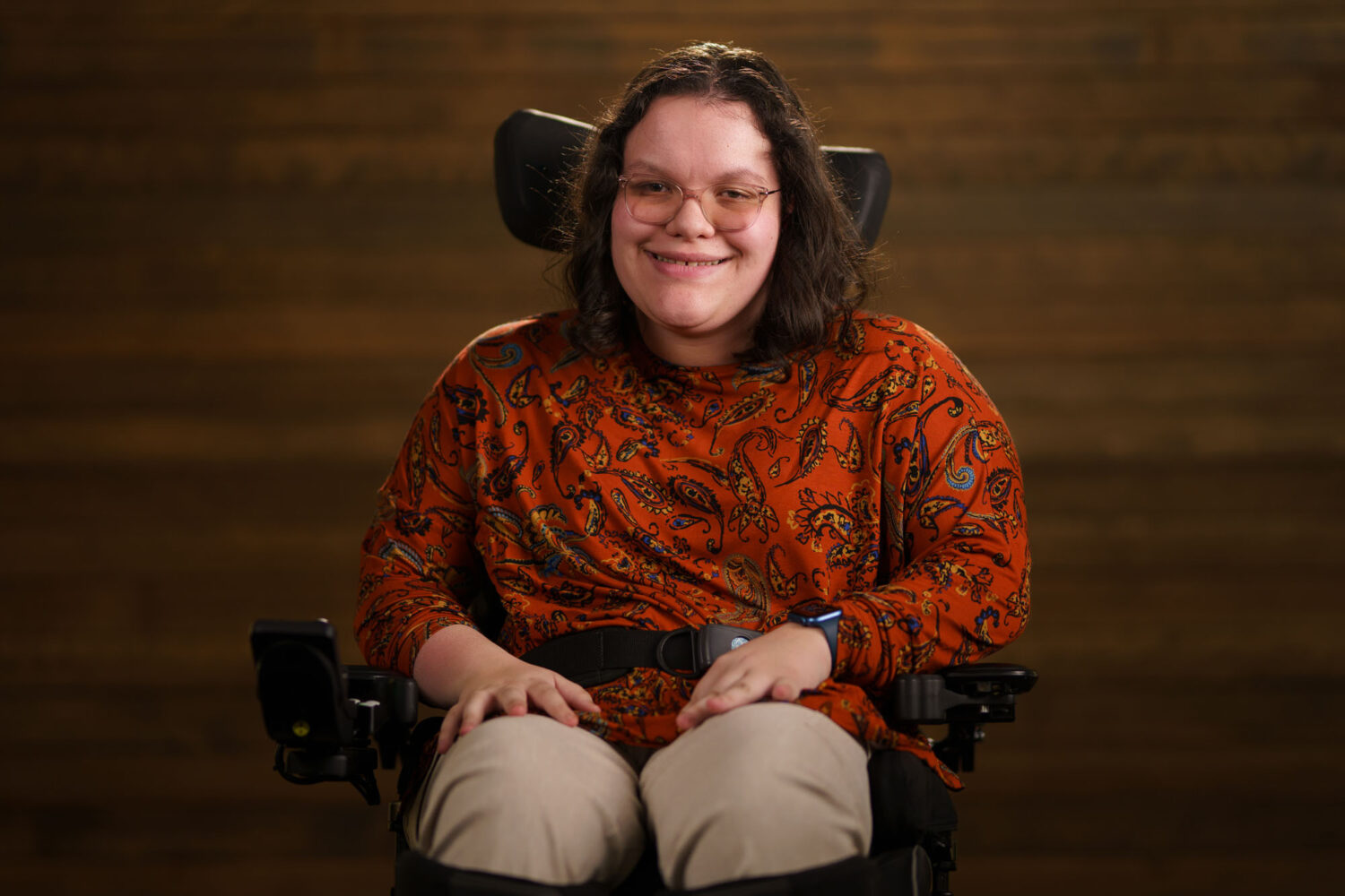 A woman in a power chair smiling. profile picture