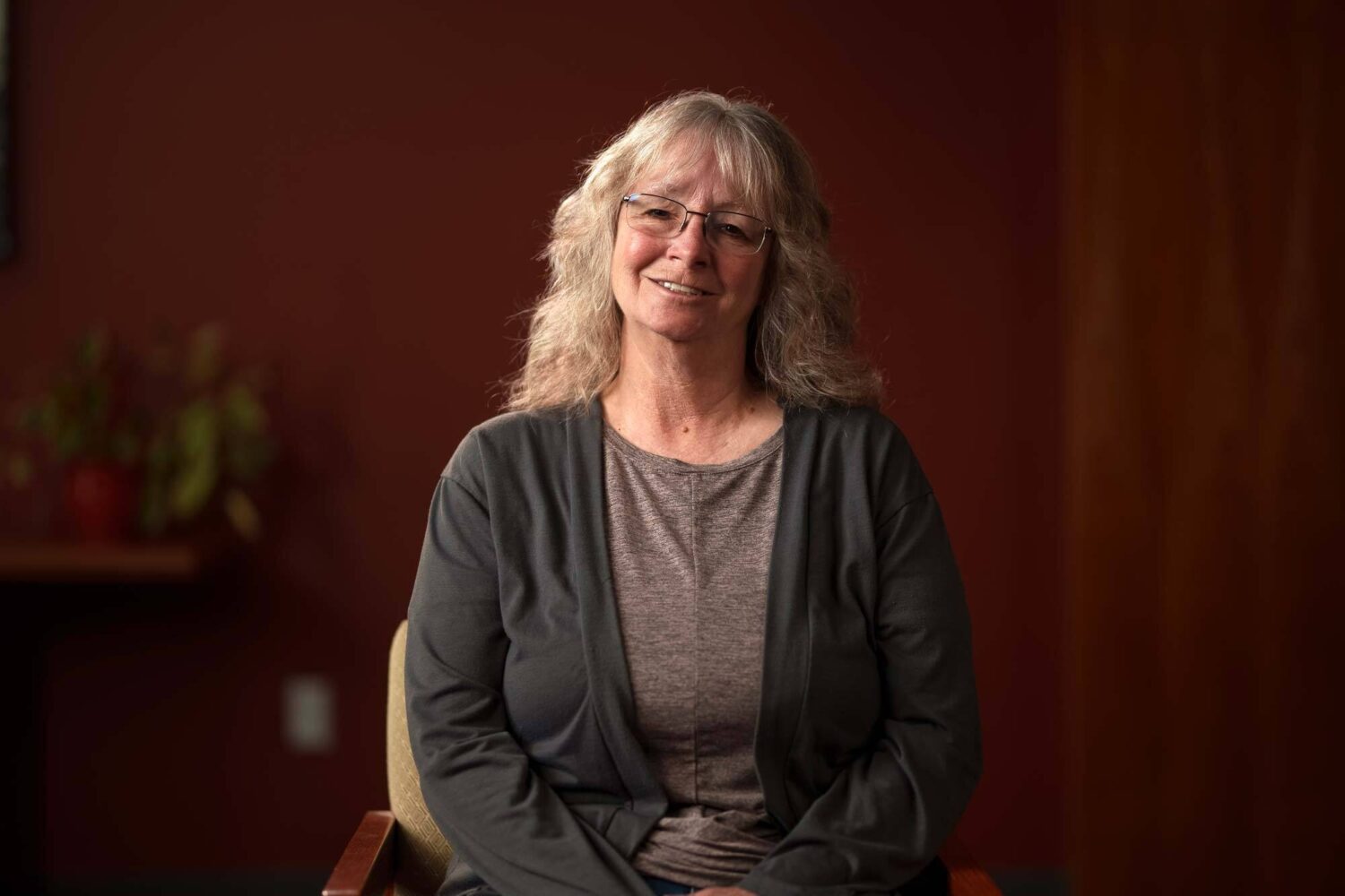 A woman sitting in a chair smiling. profile picture