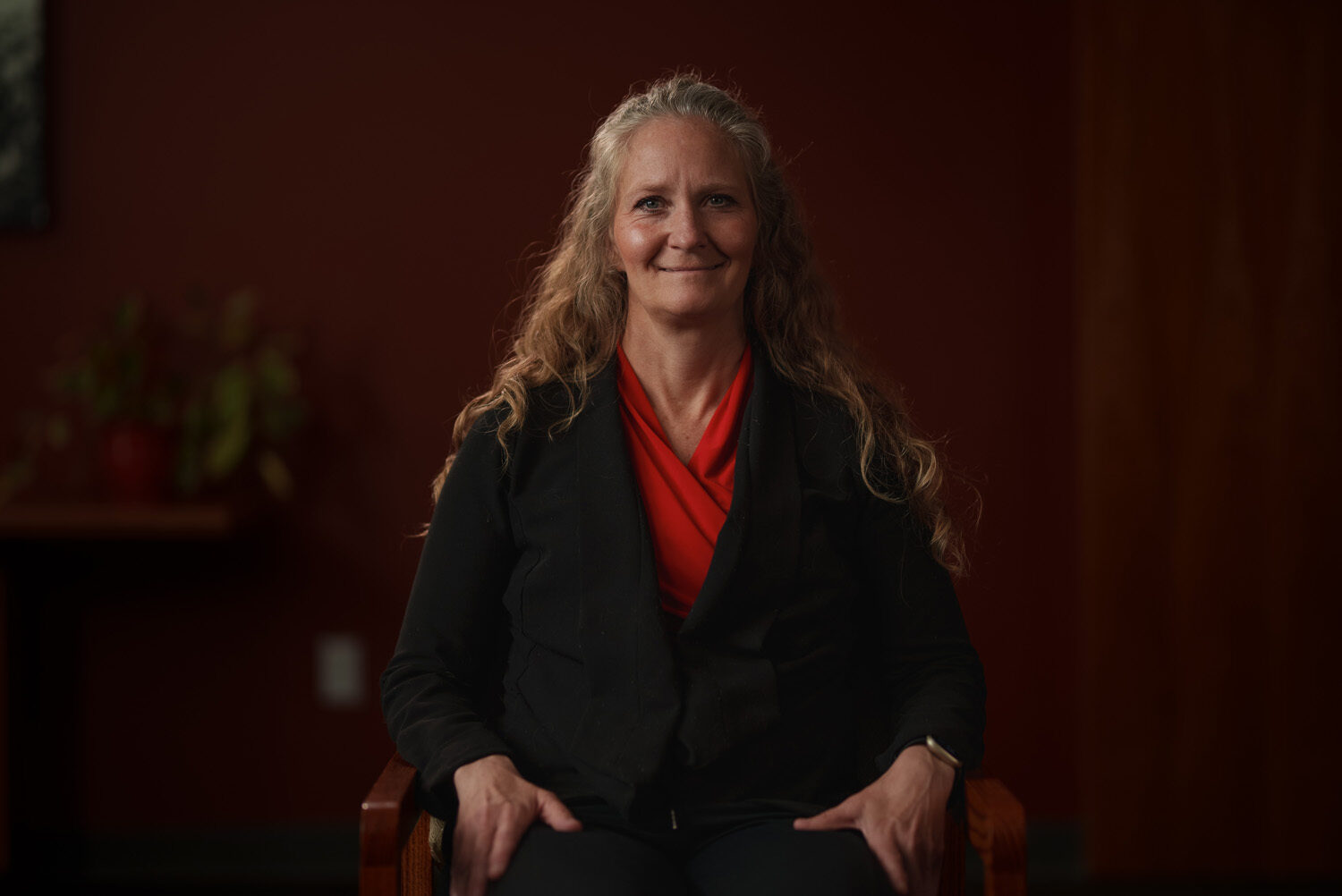A woman sitting in a chair smiling. profile picture